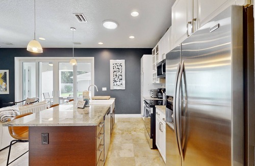 New Smyrna Beach House | Manicured home & pool house w/private pool - short walk to the ocean