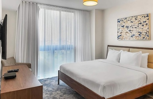 Doral Hotel | Modern 3BR City View Residence with Balcony and Luxury Amenities Near Downtown