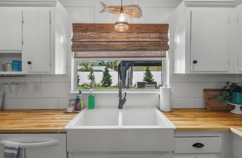 Stuart House | Modern coastal getaway with hot tub, putting green and private backyard oasis.