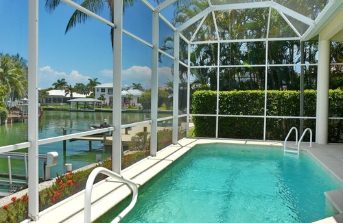 Marco Island House | Modern waterfront home with pool/view of waterways