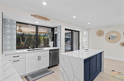 Shell Harbor House | Nestled along a pristine canal with long range views, this meticulously crafted residence defines coastal luxury at its finest.NEW!