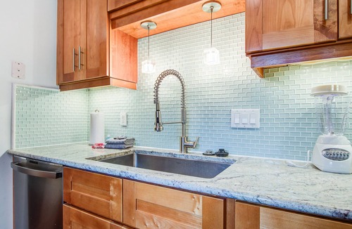 Twin Oaks House | Palm-surrounded abode with screened-in balcony, chef's kitchen, smart TVs, & W/D