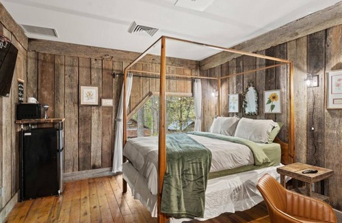 Townsend Hotel | Rustic Comfort Room - Wood Paneling and Fireplace