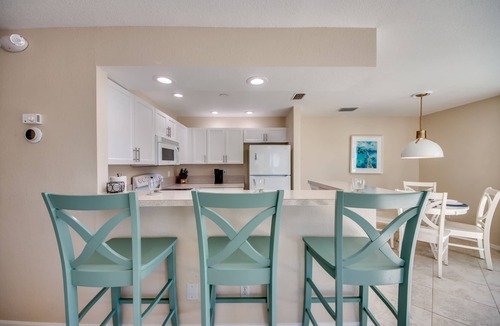 South Island House | Sand Dollar #4 - Upstairs Apt with shared Pool on Canal by the Beach!