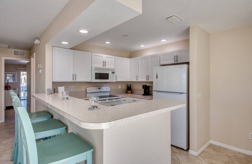 South Island House | Sand Dollar #4 - Upstairs Apt with shared Pool on Canal by the Beach!
