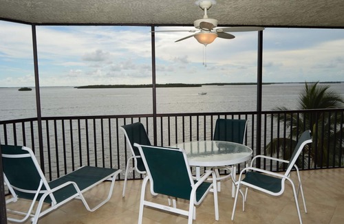 Punta Rassa Condo | Sanibel Harbour Resort Harbour Tower 315: Relaxing while watching for dolphins in the water below.