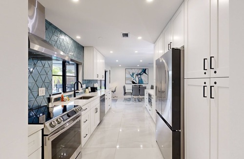 Coral Ridge Isles House | Stunning single level home with, heated pool, kitchen, & fully equipped BBQ area