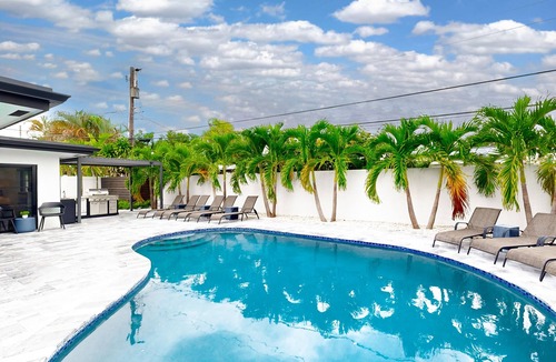 Coral Ridge Isles House | Stunning single level home with, heated pool, kitchen, & fully equipped BBQ area