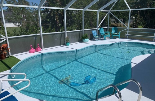 Sebastian Highlands House | Sunny Florida style home with a beautiful covered pool located near the ocean.