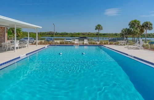 Edgewater House | The Tiki Hut Oasis, a tropical Beach home with firepit, patio, and more!