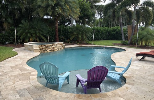 Jupiter House | Tropical waterfront oasis with private dock, pool, waterfall spa, tiki huts.