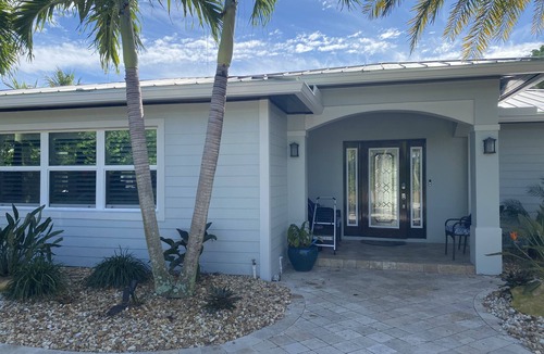 Jupiter House | Tropical waterfront oasis with private dock, pool, waterfall spa, tiki huts.
