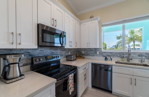 Breezeswept Beach Estates House | Villa Lucie | Canalfront home w/5 bedrooms + pool + boat lift