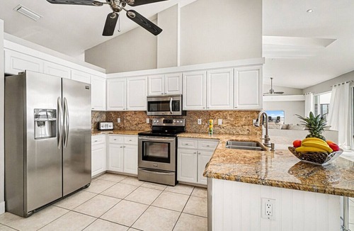 Caloosahatchee Villa | Villa Riverside – Luxury Riverfront Home w/Dock, 2 Boat Lifts, Heated Pool & Whirlpool