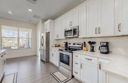 Trafalgar Village House | Water view retreat with lanai, heated pool, pool spa, game room, & AC
