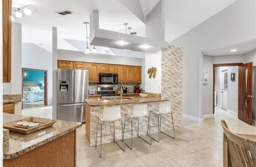 Pelican House | Waterfall saltwater Lagoon heated pool, 2 King Suites, Sauna!