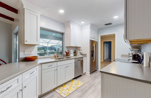 Lochmoor Waterway Estates House | Waterfront home with pool, bikes, grill, fireplace, internet, W/D, & central AC