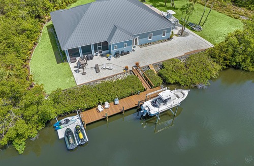 Fort Pierce Shores House | Waterfront home/steps to the beach/private dock/heated pool/spa