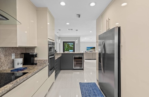 Lighthouse Point House | Waterfront~HUGE Heated Pool~Open Floor Plan~BIG Patio with Lots of Seating + Dock~Near Beaches