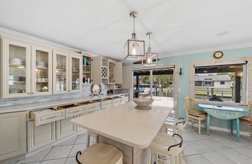 Palm Harbor House | Waterfront Retreat with Pool, Tiki Bar & Boat Dock