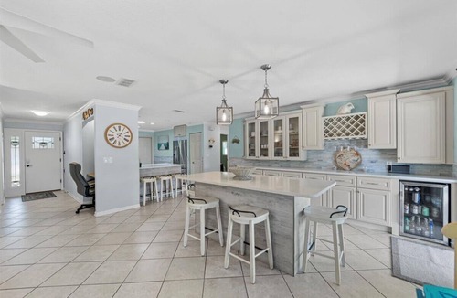 Palm Harbor House | Waterfront Retreat with Pool, Tiki Bar & Boat Dock