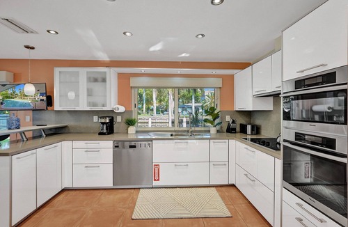 Coral Ridge Isles House | Waterfront Serenity. Pool & BBQ. Koi Pond