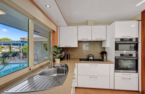 Coral Ridge Isles House | Waterfront Serenity. Pool & BBQ. Koi Pond