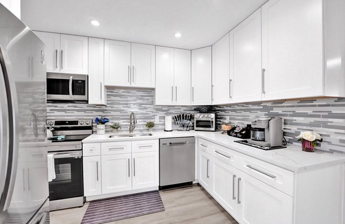 Golfview Harbor House | Waterfront Tropic Oasis: Heated Pool, Pergola, Canal, Dock, Air Hockey!