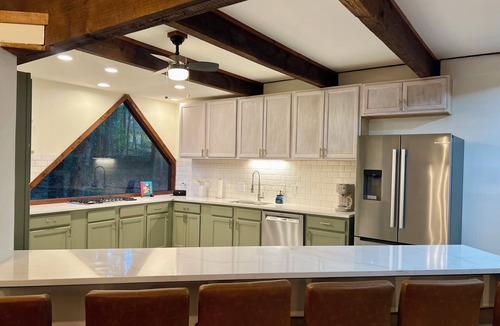 Marietta House | Wood-beam ceilings, large glass windows & a stunning spiral staircase suspended