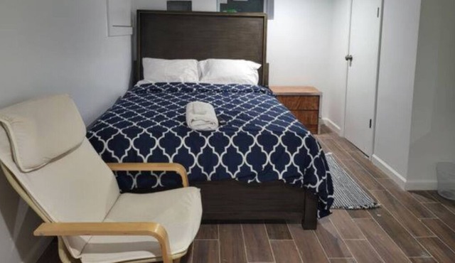 A cozy basement with queen-size beds Free WiFi, and a Smart TV with Roku.