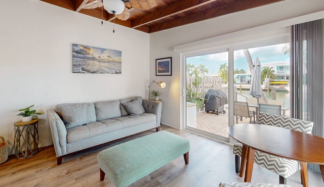 Beachy getaway with pool, water views, furnished patio, & dock access