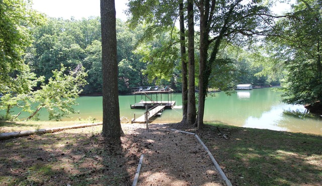 Quiet lake cove home with single slip dock