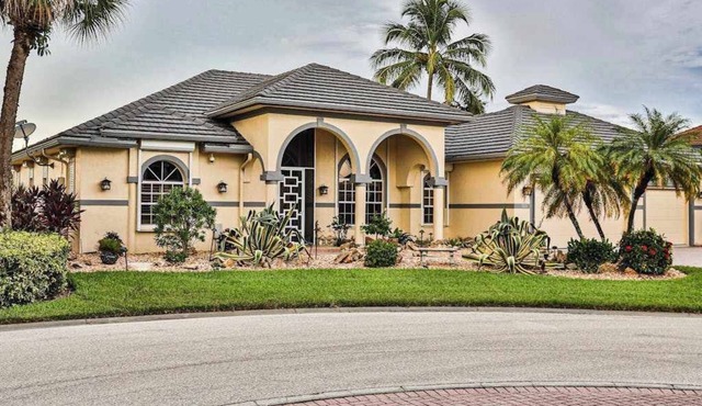 Upscale waterfront home with private dock, saltwater pool, lanai, grill, & W/D