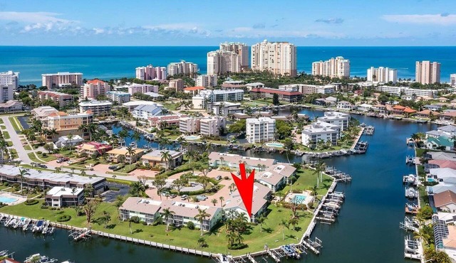 Waterfront 2BR/2BA condo with heated pool, WiFi, and marina access.