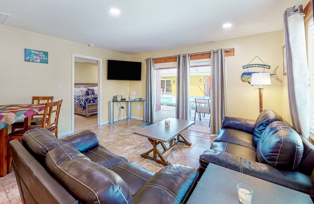 Canal-front condo with pool, boat slip, deck, central AC, & fast WiFi
