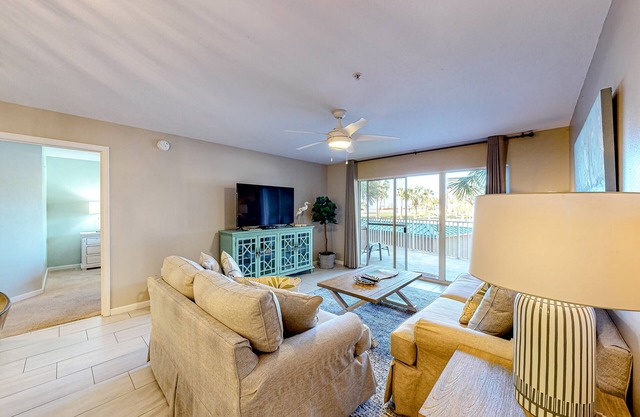 Updated 1st-floor condo with large private balcony, pool, grills, firepit, & gym