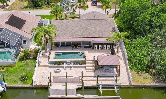 Palm Harbor House | Waterfront Retreat with Pool, Tiki Bar & Boat Dock